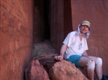 Bob sitting before huge rock cleft