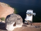 Boulder perched above houseboat