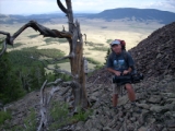 Major with camera standing by an old tree