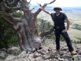 Alan standing near the fourth oldest tree