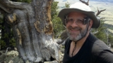 Alan standing near the fourth oldest tree