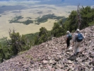 People descending steep hillside